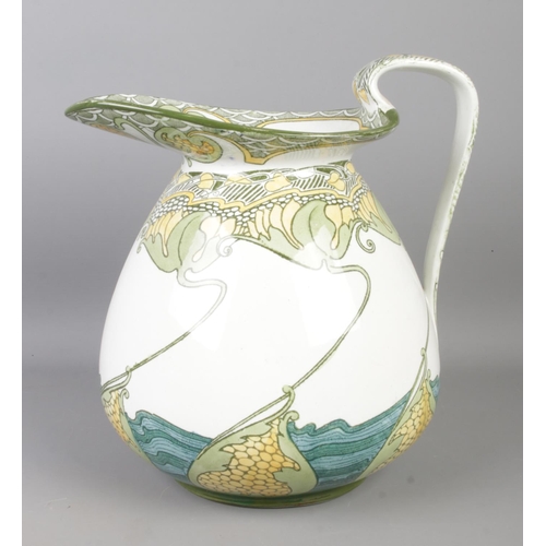 80 - A Doulton Burslem 'Kelmscot' water jug, decorated with water lilies. Height: 23cm.