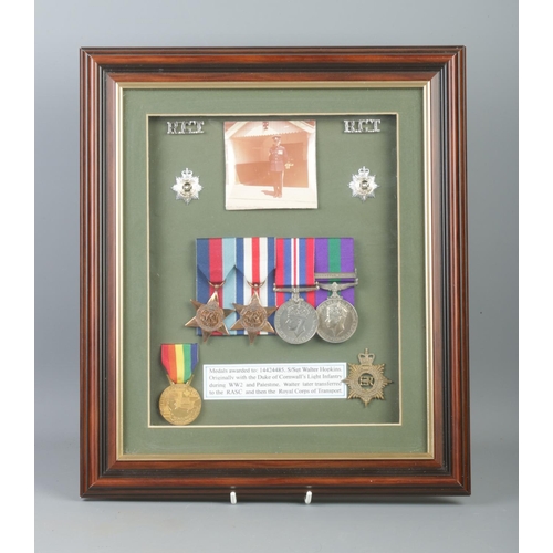 389 - A framed collection of medals and badges awarded to Corporal, later Staff Sergeant Walter Hopkins. 
... 