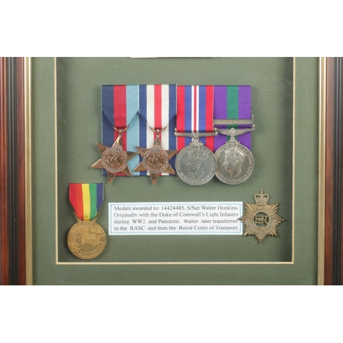 389 - A framed collection of medals and badges awarded to Corporal, later Staff Sergeant Walter Hopkins. 
... 