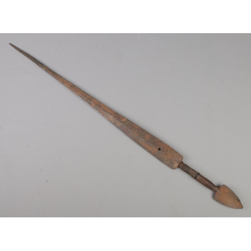 422 - An antique African tribal sword with leather wrapped grip. Length of blade 55cm.