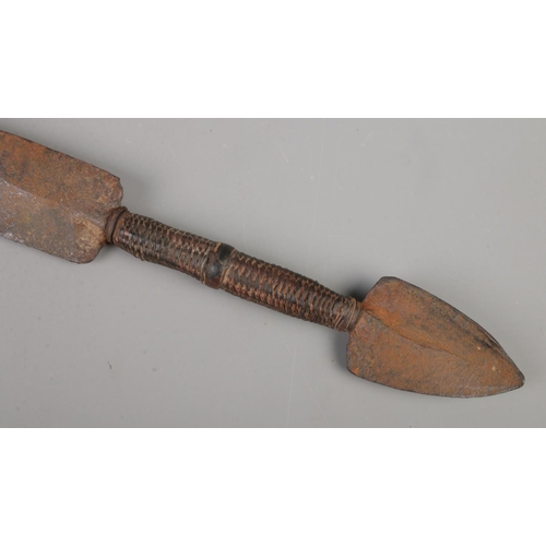 422 - An antique African tribal sword with leather wrapped grip. Length of blade 55cm.