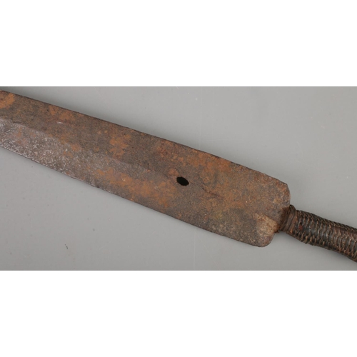 422 - An antique African tribal sword with leather wrapped grip. Length of blade 55cm.