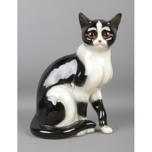 84 - A large Goebel ceramic black and white cat figurine. Height: 27cm. Stamped 31023-27 underneath.