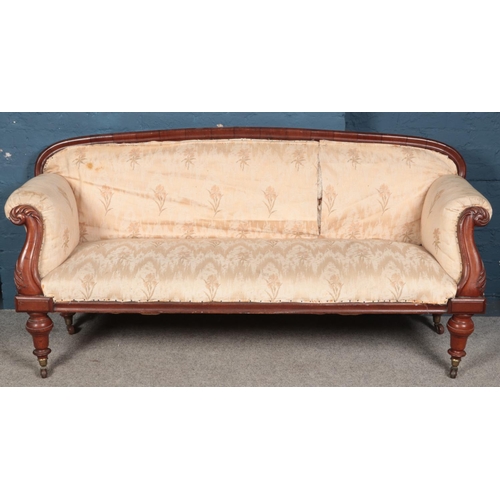 424 - A Victorian carved mahogany upholstered parlour sofa. (95cm x 190cm x 62cm)