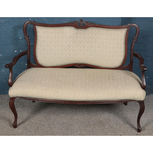 426 - A Victorian carved mahogany upholstered parlour sofa. (93cm x 125cm x 54cm)