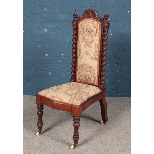 431 - A Victorian carved mahogany prayer chair with carved decoration and barley twist columns.