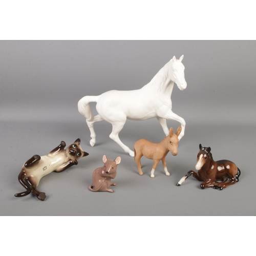 92 - A collection of Beswick ceramic animals, to include matt white horse, mouse, reclining cat, and donk... 