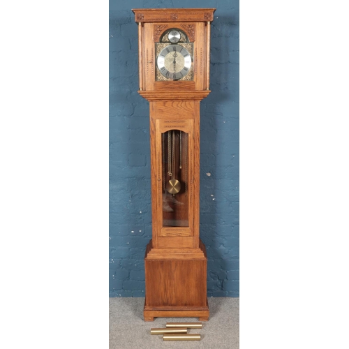 441 - A modern carved oak longcase clock. With floral decoration. (202cm x 45cm x 27cm)