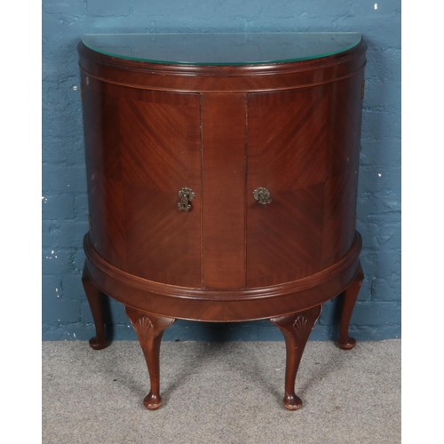 463 - A mahogany demi lune cocktail cabinet.