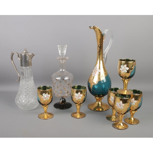 97 - Three pieces of decorative glassware, to include a silver plate topped claret jug, gilt decorated de... 