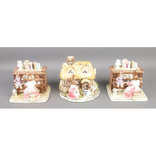 98 - Three ceramic money boxes from 'The Bunnyville Collection', a Harry James design, two depicting rabb... 