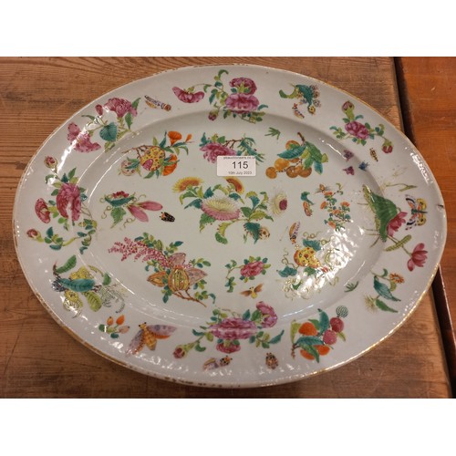 115 - A large hand painted Cantonese dish. Decorated with flower and insects. (36cm x 29cm)