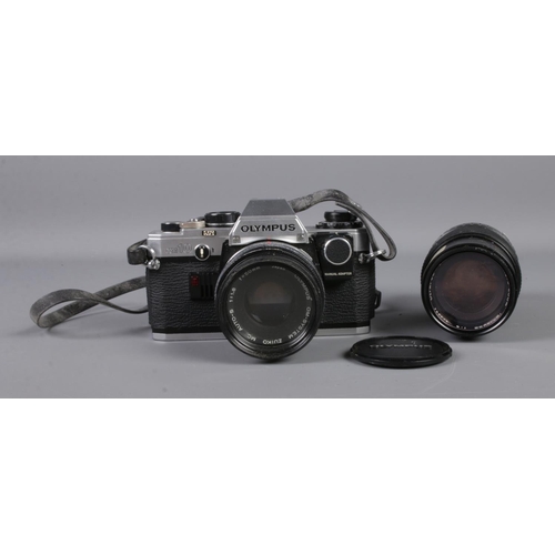 41 - An Olympus OM10 camera along with two Olympus Om-System Zuiko lens: Auto-S 1:1.8 F=50mm and Auto-Zoo... 