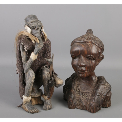 56 - Two African wooden tribal carvings. One of a seated figure, the other a bust. Height of seated figur... 