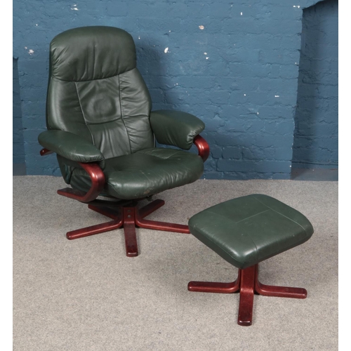 336 - A stressless swivel 'Easy' armchair and footstool in green leather