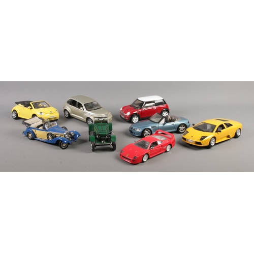 216 - A collection of assorted larger scale model vehicles. To include Ferrari F40, Chrysler PT Cruiser an... 