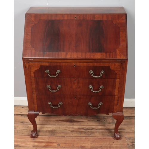 347 - A carved mahogany bureau raised on ball and claw feet with leather inset interior. (102cm x 75cm)