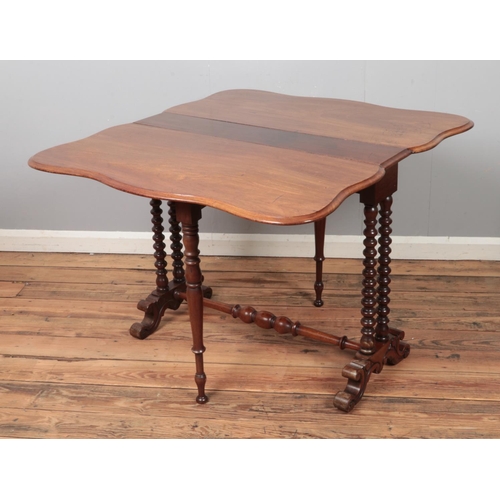 353 - A mahogany Sutherland drop-leaf table raised on bobbin turned supports. Approx. dimensions 108cm x 9... 