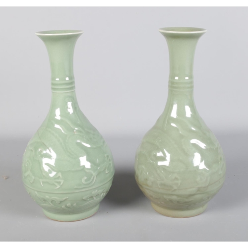 126 - A pair of 19th century Chinese Celadon vases, decorated with dragons.