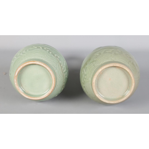 126 - A pair of 19th century Chinese Celadon vases, decorated with dragons.