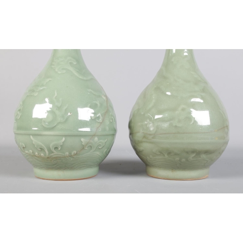 126 - A pair of 19th century Chinese Celadon vases, decorated with dragons.