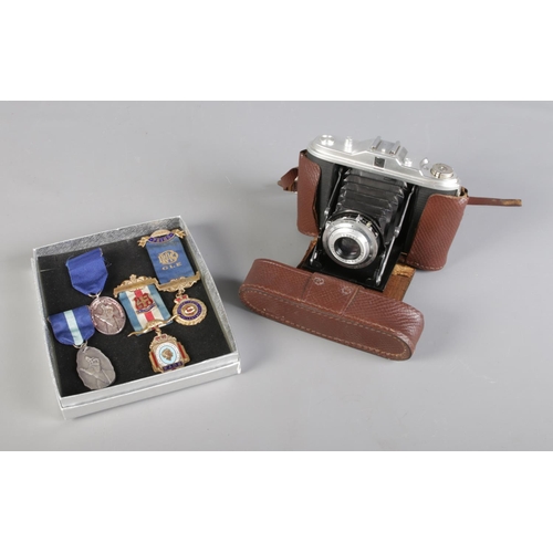 127 - A Vintage AGFA Isolette II folding bellows camera toghether with a collection of mostly RAOB enamell... 