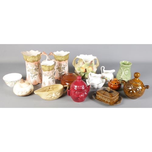 128 - A collection of ceramics. Includes Sylvac food jars, Victorian graduated jugs, etc.