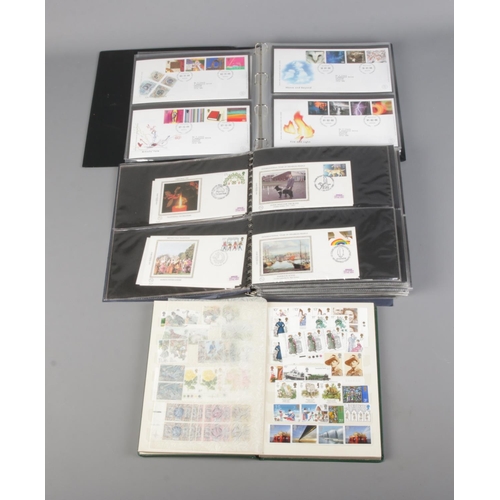 19 - Two albums of First Day covers along with album of unfranked, mostly commemorative, British stamps .... 