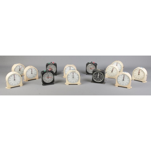 135 - A collection of timing clocks and stopwatches, to include enamel and Smiths examples.