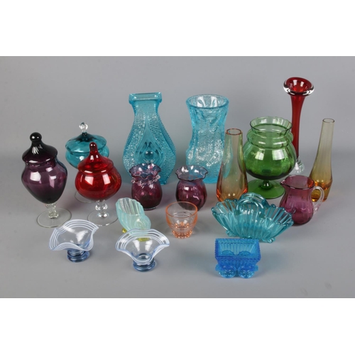 141 - A collection of assorted coloured glassware to include cranberry glasses, bubble vases, baskets, etc... 