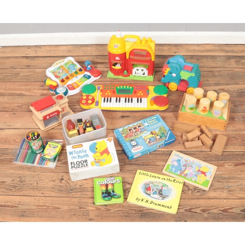 143 - A quantity of children's toys and games including child's keyboard, elephant walker, puzzles and mor... 