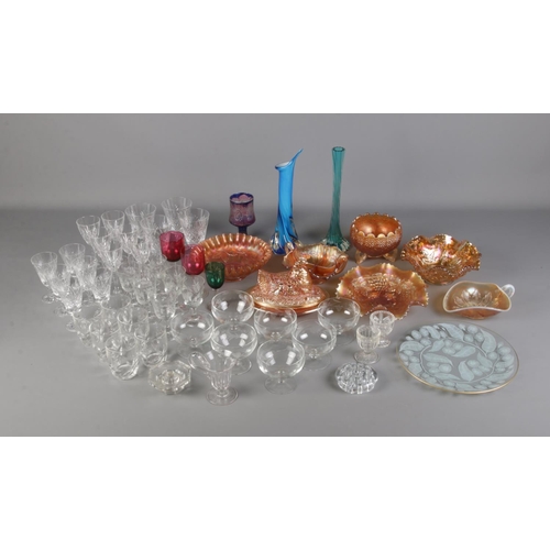 174 - A box of glassware including carnival glass pieces as well as coloured glass vases, cut glass and pr... 