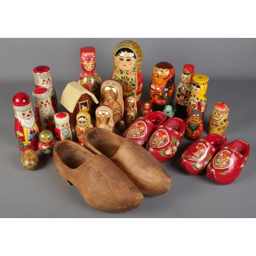 176 - A large quantity of Russian Dolls along with three pairs of Clogs. Includes religious examples, etc.