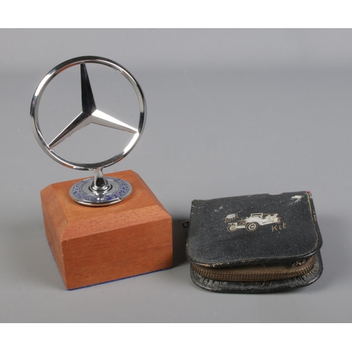 36 - A mounted Mercedes three point star mascot along with pocket tool kit in leather zip case.