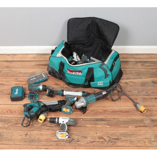 202 - A large Makita carry bag with a quantity of power tools including nail gun, drills, jigsaw, angle gr... 