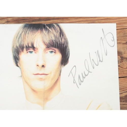 54 - A signed Paul Weller wall poster. Approx. poster dimensions 42cm x 99cm.