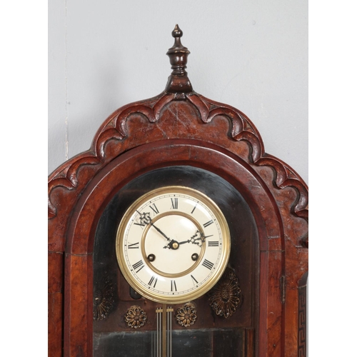 222 - A mahogany and walnut cased wall clock, with carved arched top and 'Greek Key' column detailing. Fea... 