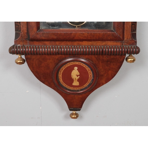 222 - A mahogany and walnut cased wall clock, with carved arched top and 'Greek Key' column detailing. Fea... 