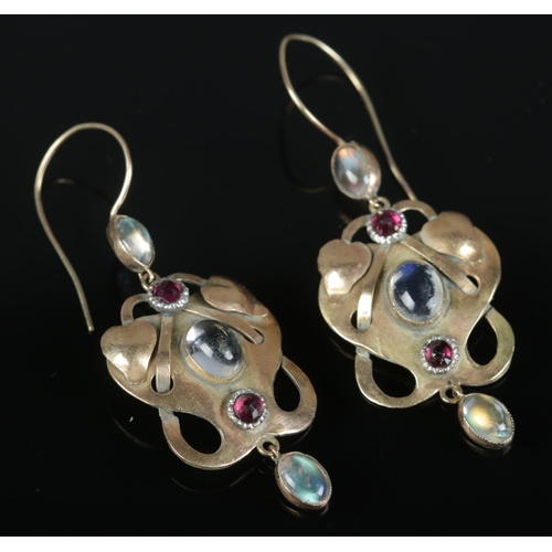 239 - A pair of 9ct gold art and crafts earrings set with moonstones and garnets. 4.05g gross weight.