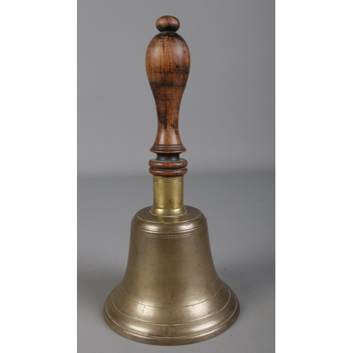 74 - A brass school bell with turned wooden handle. (25cm)