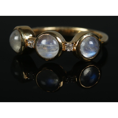 262 - A moonstone and diamond trilogy ring set in 14ct gold vermeil band. Size S, 3.8g