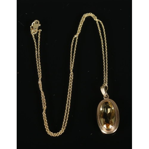 268 - A 9ct gold citrine pendant on chain. Total weight 5.6g.