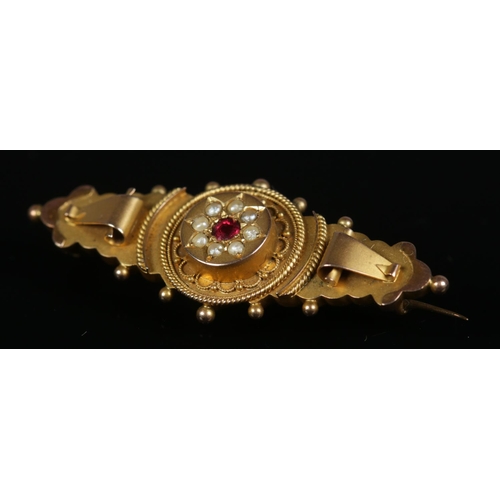 271 - A 9ct gold Victorian bar brooch set with central spinel surrounded by seed pearls. Total weight 3.3g... 