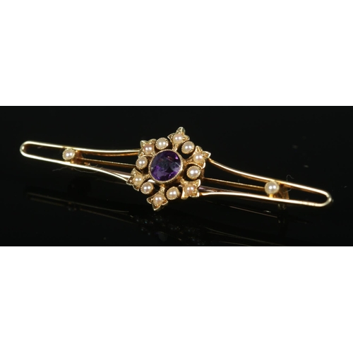 274 - An Edwardian 15ct gold bow brooch set with central amethyst and seed pearl. Pin stamped 9ct. Total w... 