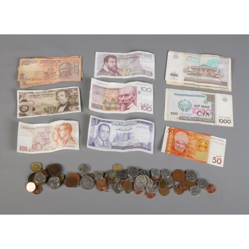 84 - A quantity of coins and bank notes from various countries including Belgium, Uzbekistan, Austria, Mo... 