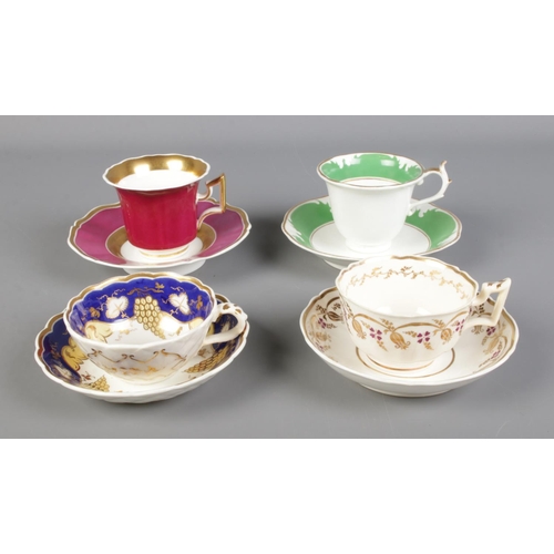 290 - A collection of four Rockingham teacup and saucers sets. Two bearing puce griffin and two bearing re... 