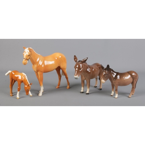 299 - Two Beswick Donkeys, together with two Beswick Palomino horses, H259, and foal.