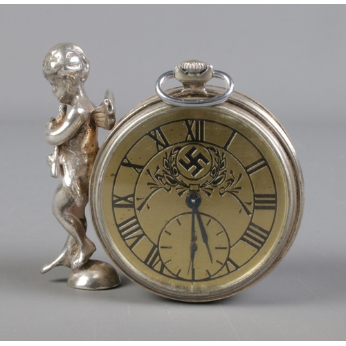 303 - An early 20th century white metal clock bearing Swastika to face and decorative cherub to side. Move... 