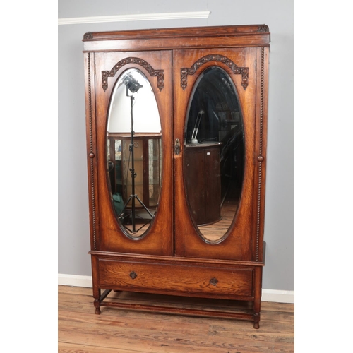 315 - 1930's oak wardrobe with mirrored double doors. Approx. dimensions 120cm x 197cm x 44cm.