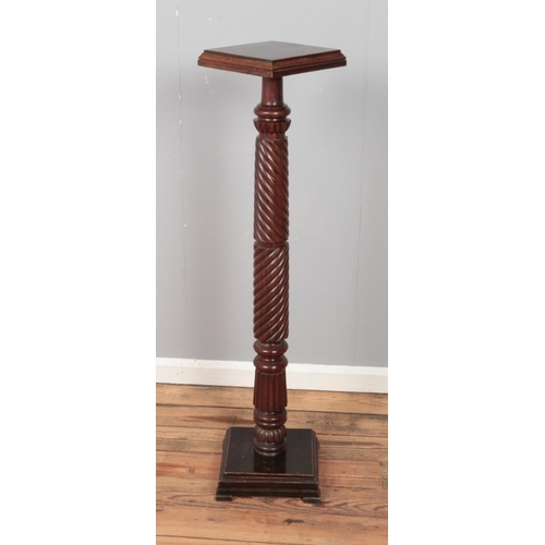 317 - A carved mahogany Torchere plant/ornament stand. Approx. height 126cm.